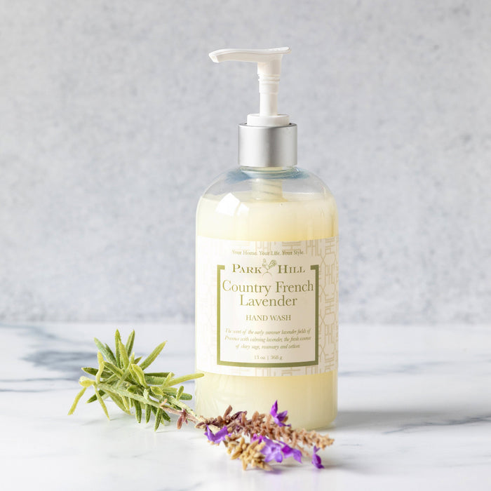 Bottle of Park Hill Country French Lavender hand wash with lavender sprigs on a light background