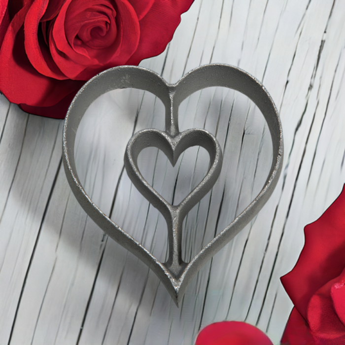 Heart shaped rosette cookie iron on white table with roses  for Valentine's Day