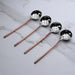 Four slotted spoons on marble background