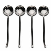 Set of four silver spoons on a white background