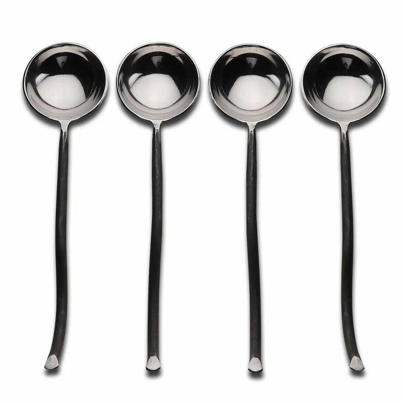Set of four silver spoons on a white background