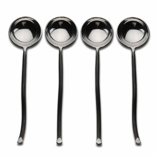 Set of four silver spoons on a white background