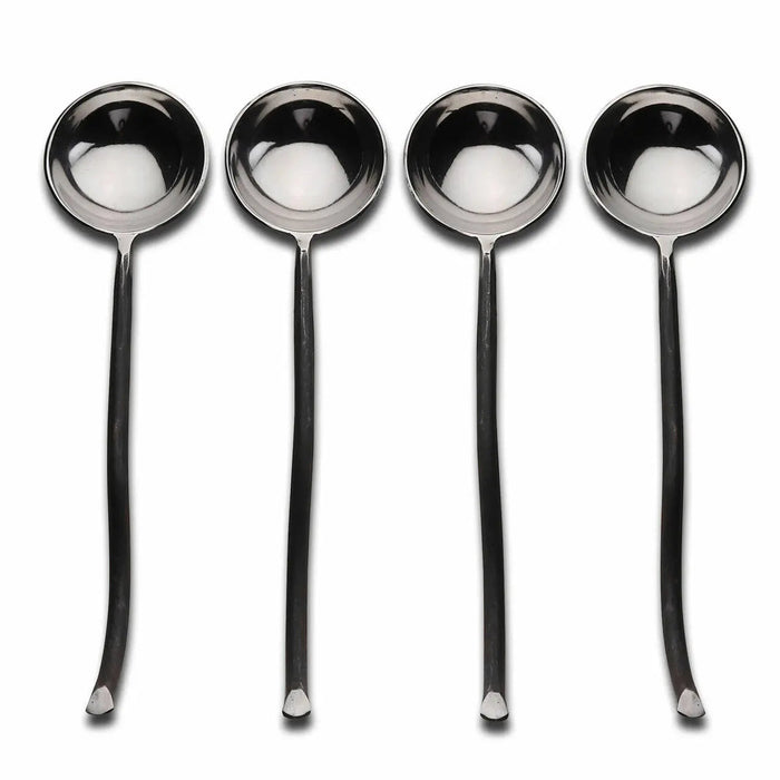 Set of four silver spoons on a white background