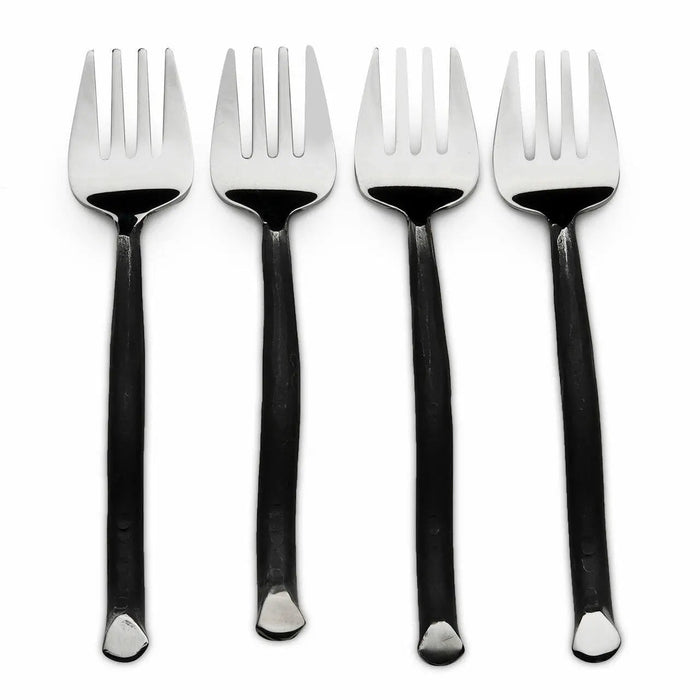 Four black-handled forks with silver tips on a white background